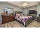 Cozy main bedroom with wood-look flooring, a ceiling fan, and a tray ceiling at 107 Trisha Ln, Grantville, GA 30220
