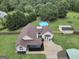 Aerial view of home with in-ground pool, lush lawn, and mature tree coverage at 250 Stallsworth Rd, Mcdonough, GA 30252