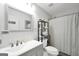 Bathroom features a gray vanity with a framed mirror, shelf with towels and a shower at 250 Stallsworth Rd, Mcdonough, GA 30252