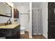 Clean bathroom featuring a shower with a curtain, a vanity, and a wooden cabinet at 250 Stallsworth Rd, Mcdonough, GA 30252
