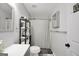 Well-lit bathroom features a shower with curtain, toilet and a shelf with towels at 250 Stallsworth Rd, Mcdonough, GA 30252