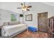 Bedroom with a wooden ceiling fan, hardwood floors, and white walls at 250 Stallsworth Rd, Mcdonough, GA 30252