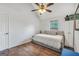 Bedroom featuring a wooden ceiling fan, hardwood floors, and a window at 250 Stallsworth Rd, Mcdonough, GA 30252