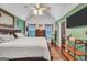 Bright bedroom with a king-sized bed, a ceiling fan, and a television mounted on the wall at 250 Stallsworth Rd, Mcdonough, GA 30252