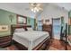 The main bedroom features a wooden framed mirror and windows that allow natural lighting to come in at 250 Stallsworth Rd, Mcdonough, GA 30252