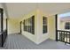 Charming front porch with gray painted floor, black railings, and light yellow siding at 250 Stallsworth Rd, Mcdonough, GA 30252