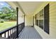 Inviting covered front porch with gray painted floor, black railings, and view of the lawn at 250 Stallsworth Rd, Mcdonough, GA 30252