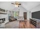 Spacious living room boasting hardwood floors, a fireplace, and views of the backyard at 250 Stallsworth Rd, Mcdonough, GA 30252