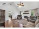 Cozy living room features hardwood floors, a brick fireplace, and plenty of natural light at 250 Stallsworth Rd, Mcdonough, GA 30252