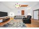 Spacious living room features a ceiling fan, gray sofa, and flat screen TV at 250 Stallsworth Rd, Mcdonough, GA 30252