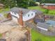 Aerial view of two-story home with brick features, spacious driveway, trampoline, and a fenced backyard at 5436 Ahyoka Dr, Morrow, GA 30260