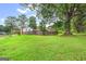 Backyard view of home featuring a wooden fence and expansive green space with a large tree at 5436 Ahyoka Dr, Morrow, GA 30260