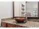 Bathroom featuring a granite countertop, stylish bowl sink, ornate framed mirror, and a modern faucet at 5436 Ahyoka Dr, Morrow, GA 30260