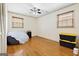 Bright bedroom with hardwood floors, a ceiling fan, closet space, and natural light from two windows at 5436 Ahyoka Dr, Morrow, GA 30260