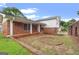 Beautiful home featuring a red brick exterior, a covered porch, and a well-manicured lawn at 5436 Ahyoka Dr, Morrow, GA 30260