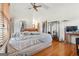 Spacious primary bedroom with ceiling fan, a clothing rack, and hardwood floors at 5436 Ahyoka Dr, Morrow, GA 30260