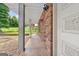 A cozy porch with brick walls and columns, showcasing a warm welcome to the home at 5436 Ahyoka Dr, Morrow, GA 30260