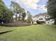 Large backyard showcasing an in-ground pool, mature trees, and ample green space at 2325 Lochinver Sw Ln, Conyers, GA 30094
