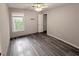 Bedroom features light gray walls and gray wood flooring at 2325 Lochinver Sw Ln, Conyers, GA 30094