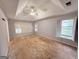 Bedroom with tray ceiling, ceiling fan, and shuttered windows at 2325 Lochinver Sw Ln, Conyers, GA 30094