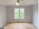 Bedroom featuring a ceiling fan and large windows at 2325 Lochinver Sw Ln, Conyers, GA 30094
