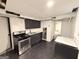 Basement kitchen with stainless steel appliances, black cabinetry, and compact design at 2325 Lochinver Sw Ln, Conyers, GA 30094