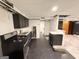 Undersized basement kitchen with stainless appliances, black cabinets, and potential for renovation at 2325 Lochinver Sw Ln, Conyers, GA 30094