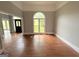 Sunlit living room with large windows and hardwood floors at 2325 Lochinver Sw Ln, Conyers, GA 30094