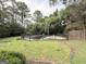 Inviting in-ground swimming pool surrounded by lush greenery and a secure fence at 2325 Lochinver Sw Ln, Conyers, GA 30094