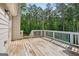Wooden back deck and railing overlooking a lush backyard filled with trees at 2565 Aaron Ct, Loganville, GA 30052