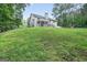Expansive backyard featuring a deck, mature trees, and lush green lawn at 2565 Aaron Ct, Loganville, GA 30052