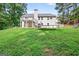 Large backyard with a deck, lower patio, trampoline, and playset at 2565 Aaron Ct, Loganville, GA 30052
