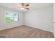 Bright bedroom featuring neutral walls, carpeting, and a ceiling fan with attached lighting at 2565 Aaron Ct, Loganville, GA 30052