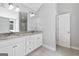 A luxurious main bathroom with double vanity, granite countertops, and abundant lighting at 2565 Aaron Ct, Loganville, GA 30052