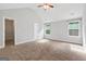 Serene main bedroom with plush carpet, vaulted ceiling, and plenty of natural light at 2565 Aaron Ct, Loganville, GA 30052