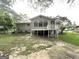 Backyard view of the home featuring a sunroom and raised porch at 4385 Midway Rd, Douglasville, GA 30134