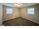 Neutral bedroom with plush carpeting and a pair of bright windows at 4385 Midway Rd, Douglasville, GA 30134