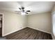 This bedroom is illuminated by a ceiling fan and showcases sleek, modern vinyl flooring at 4385 Midway Rd, Douglasville, GA 30134