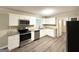 Newly renovated kitchen featuring stainless steel appliances, granite countertops, and white cabinetry at 4385 Midway Rd, Douglasville, GA 30134