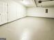 Spacious basement featuring concrete floors and white doors for storage at 5156 Allison Way, Sugar Hill, GA 30518