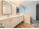Bathroom with double vanity, marble countertops, and modern mirrors at 5156 Allison Way, Sugar Hill, GA 30518