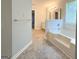 Bathroom with a tub, double vanity, and modern fixtures at 5156 Allison Way, Sugar Hill, GA 30518