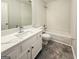 Bright bathroom featuring a sink, toilet, shower, and tiled floor at 5156 Allison Way, Sugar Hill, GA 30518