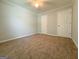 This bedroom features neutral walls, carpet, and a ceiling fan at 5156 Allison Way, Sugar Hill, GA 30518