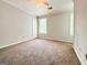 Spacious bedroom with neutral walls, ceiling fan, carpeted floor, and bright windows at 5156 Allison Way, Sugar Hill, GA 30518