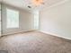 Bright bedroom featuring neutral walls and carpet, a ceiling fan and natural light at 5156 Allison Way, Sugar Hill, GA 30518
