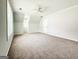 Carpeted bedroom featuring a ceiling fan, neutral walls and natural light at 5156 Allison Way, Sugar Hill, GA 30518