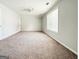 Neutral bedroom with carpet, ceiling fan and window providing natural light at 5156 Allison Way, Sugar Hill, GA 30518