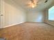 Bright bedroom with tan carpet, neutral paint, and a ceiling fan at 5156 Allison Way, Sugar Hill, GA 30518