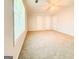 Large, bright bedroom with tan carpet and three white doors at 5156 Allison Way, Sugar Hill, GA 30518
